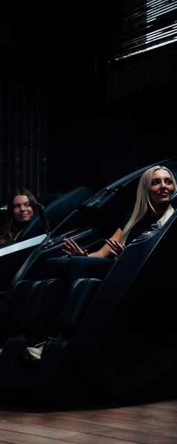 Two guests relaxing in the Zero Gravity massage chairs